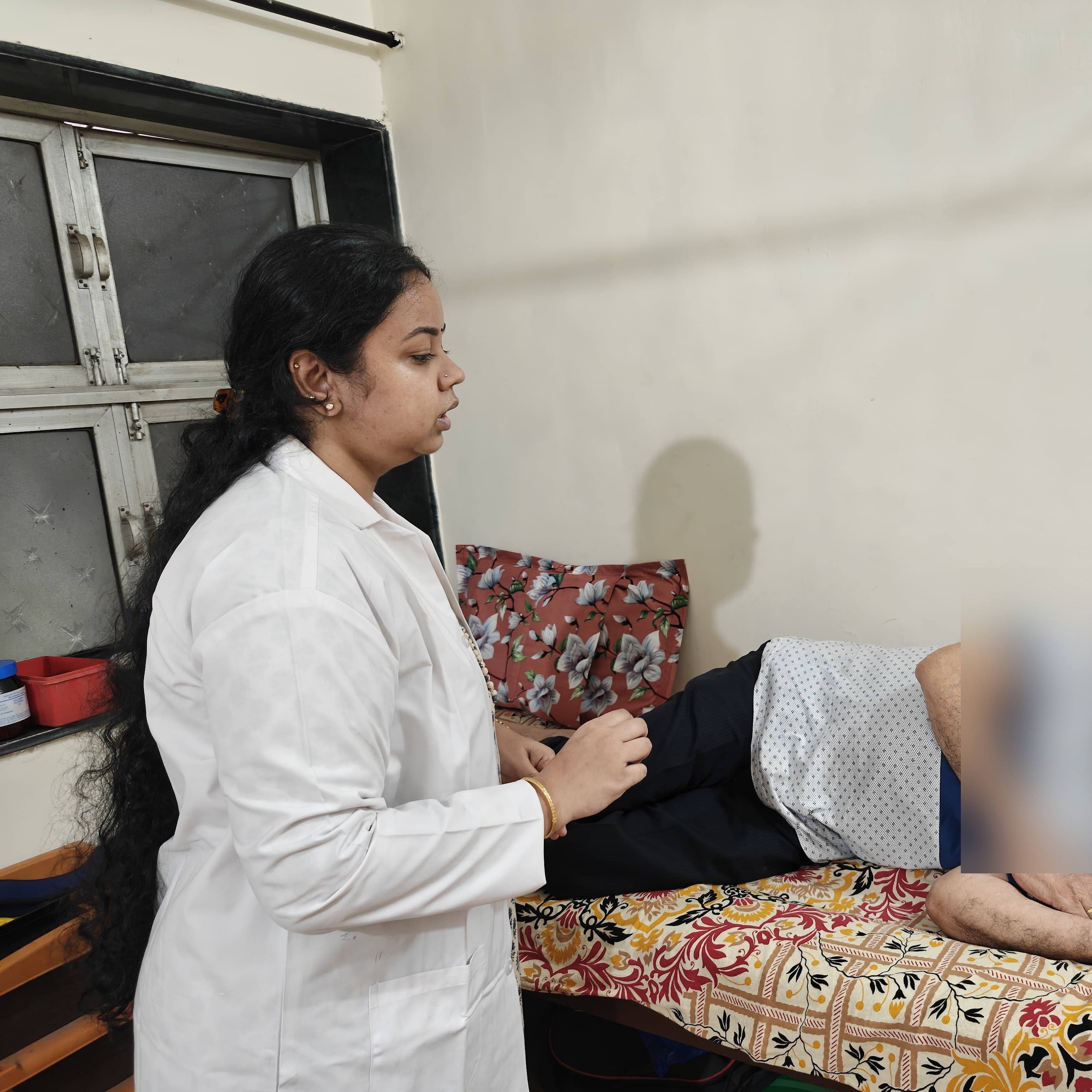 Dr. Shraddha Krishnamoorthy assisting a patient