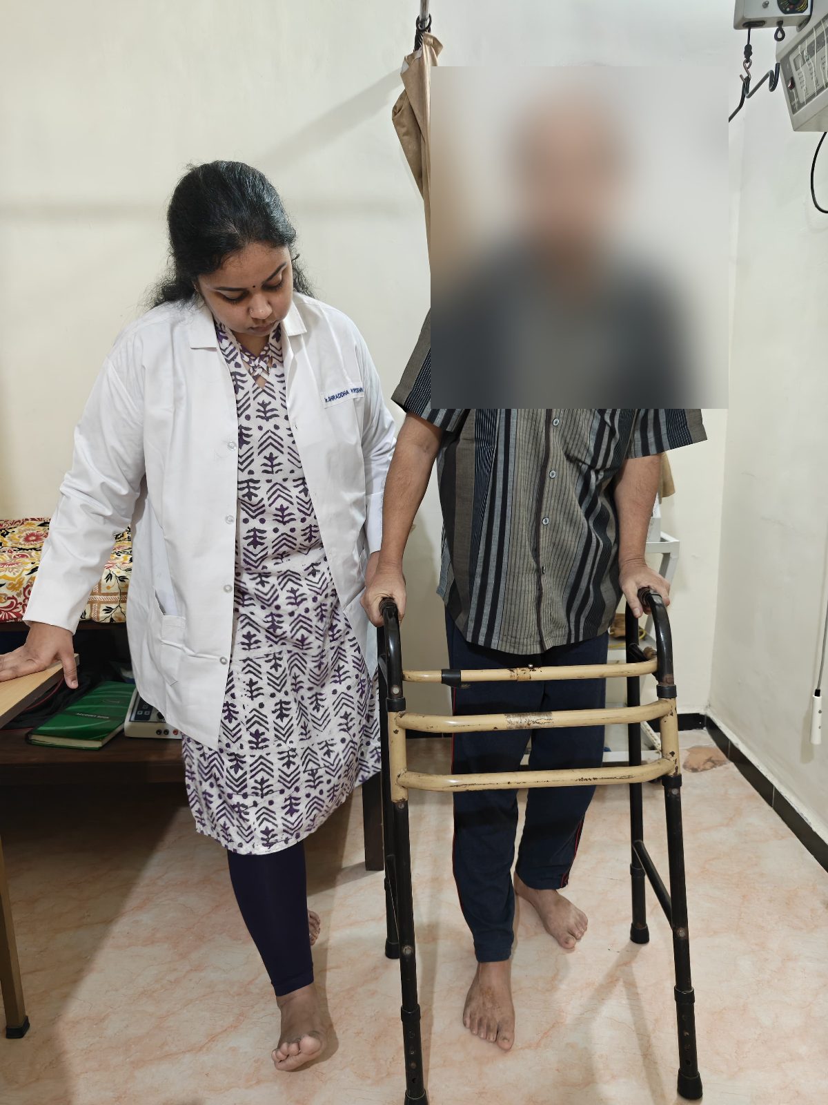 Dr. Shraddha Krishnamoorthy assisting a patient with gait training
